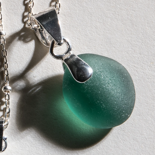 Beautifully rounded, rare deep teal sea glass set in 14 Karat gold fill bale and 18 inch gold fill chain. 